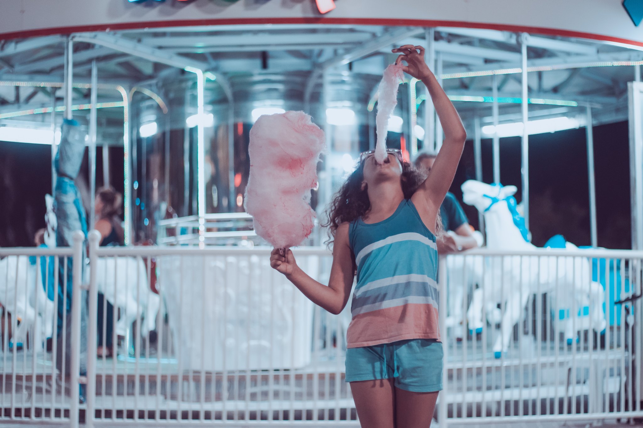girl eating cotton candy